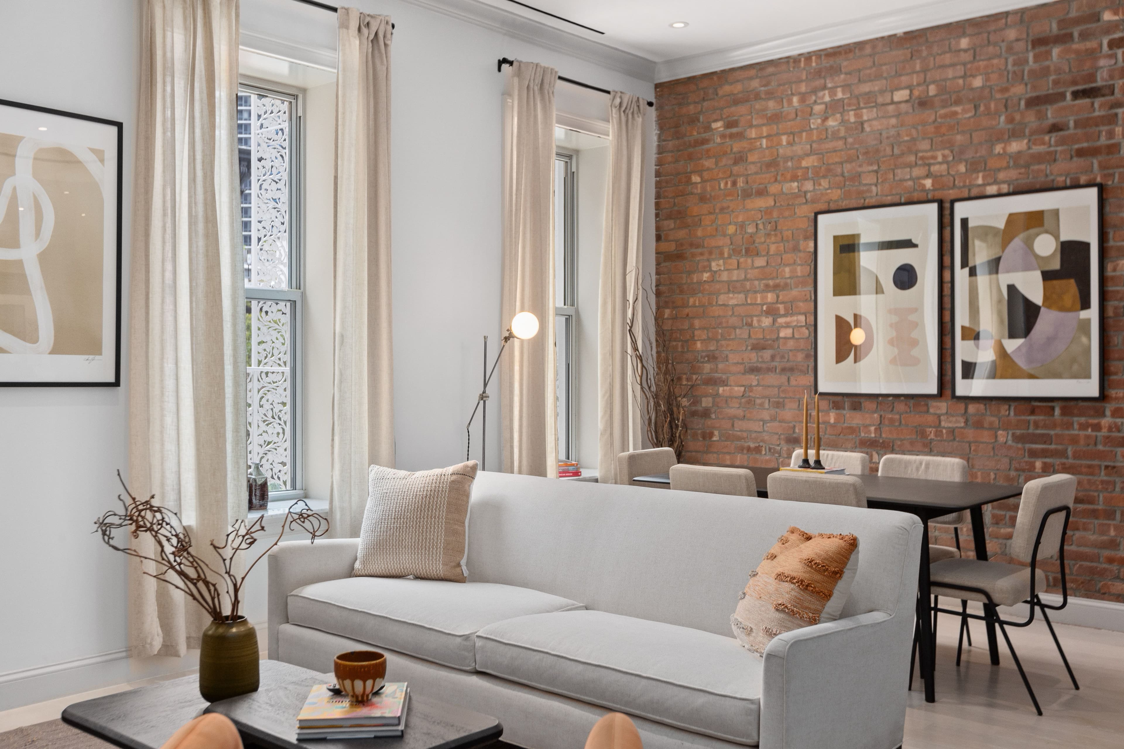 Furnished Rental in Upper East Side NYC apartment with brick wall, dining table and couch