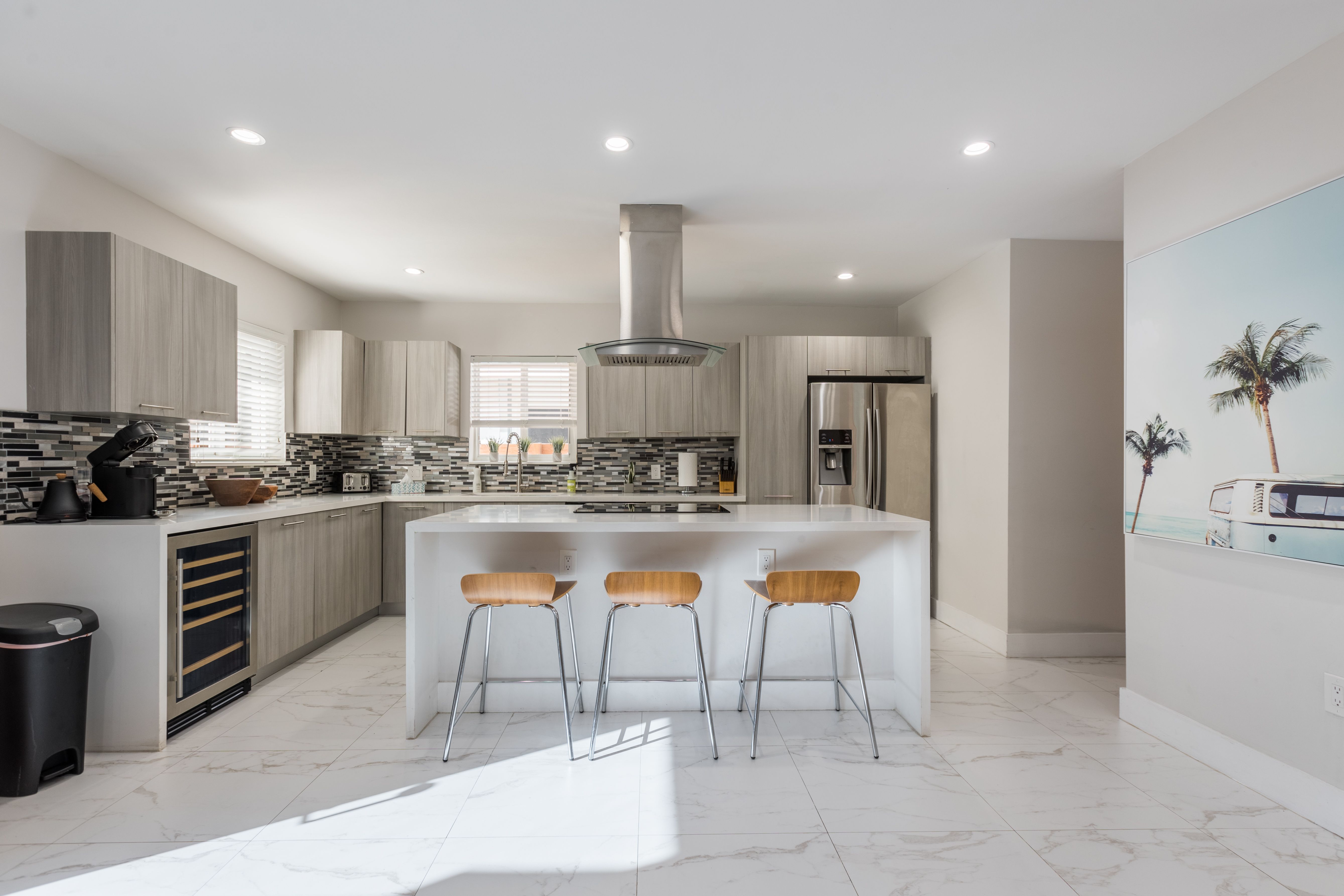Fully stocked kitchen of vacation rental in fort lauderdale with kitchen island and bar stools