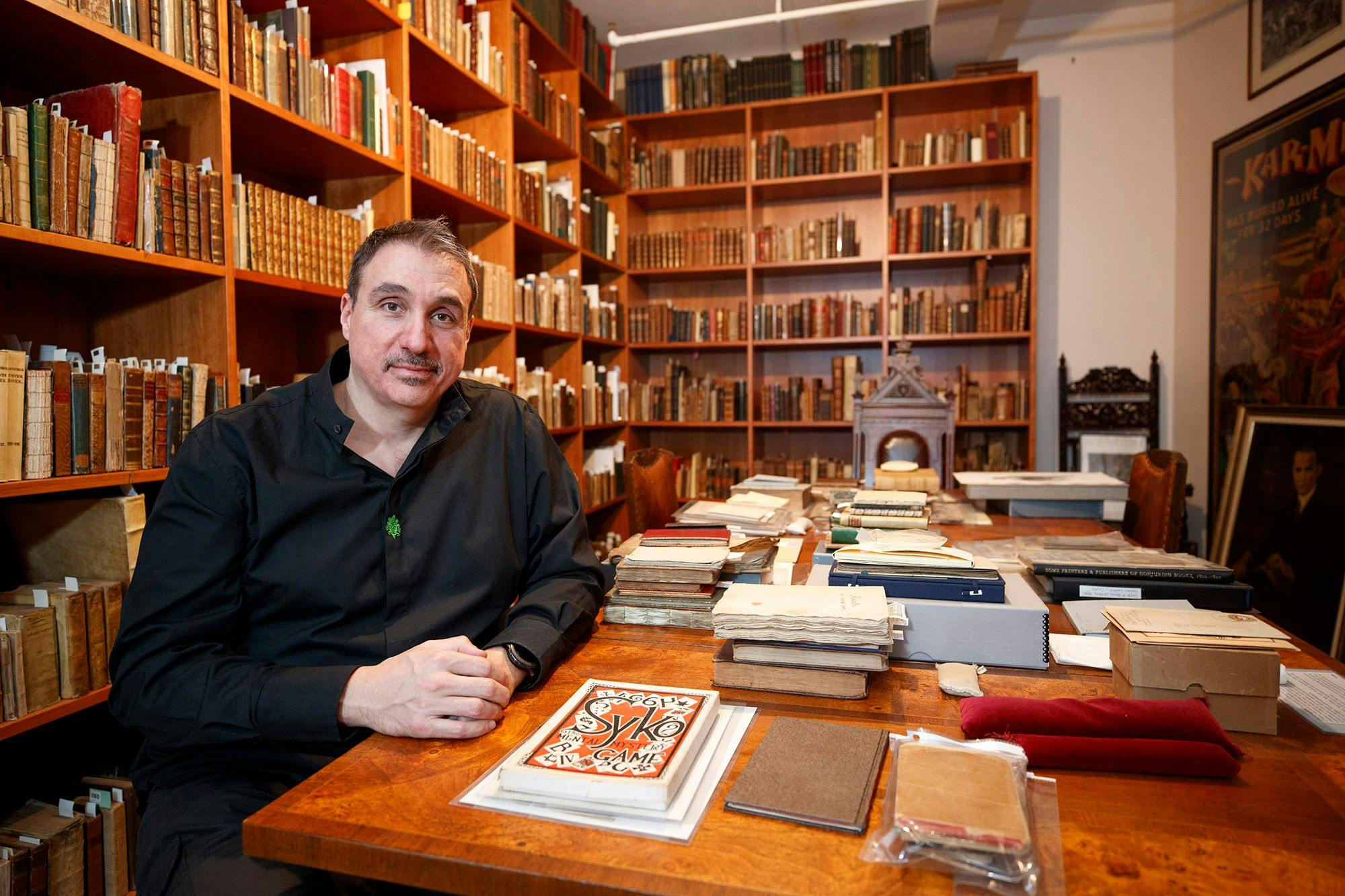 William Kalush poses in the Conjuring Arts Research Center library